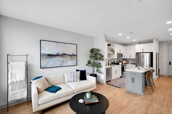 a living room with a couch and a table at Preston Ridge, Cary